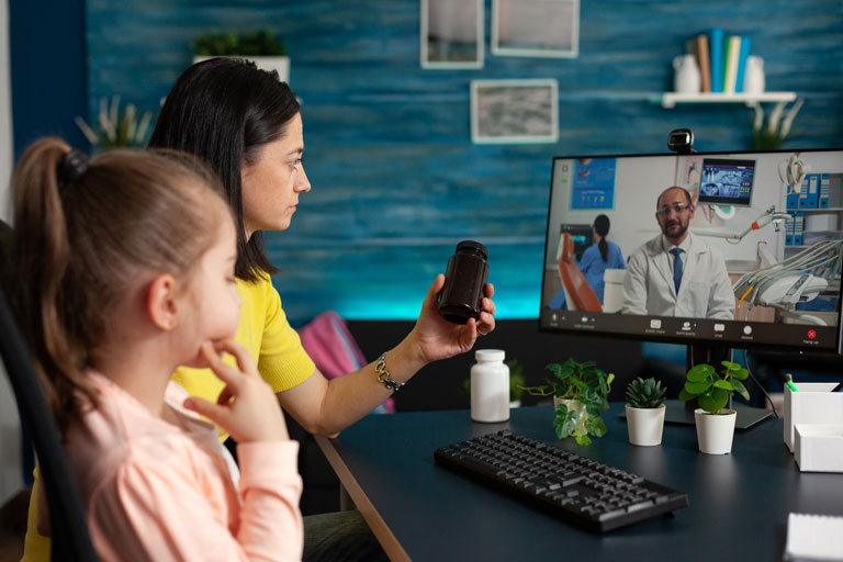 Mother discussing medicine options for her daughter via virtual medic