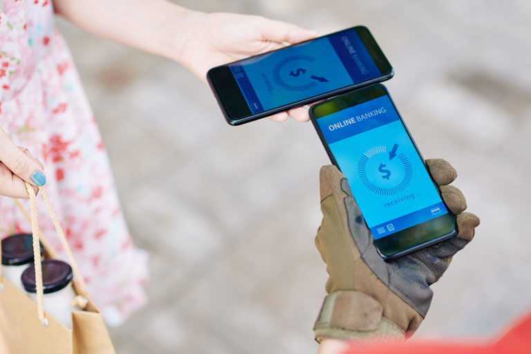 Woman paying for a delivery with a smartphone